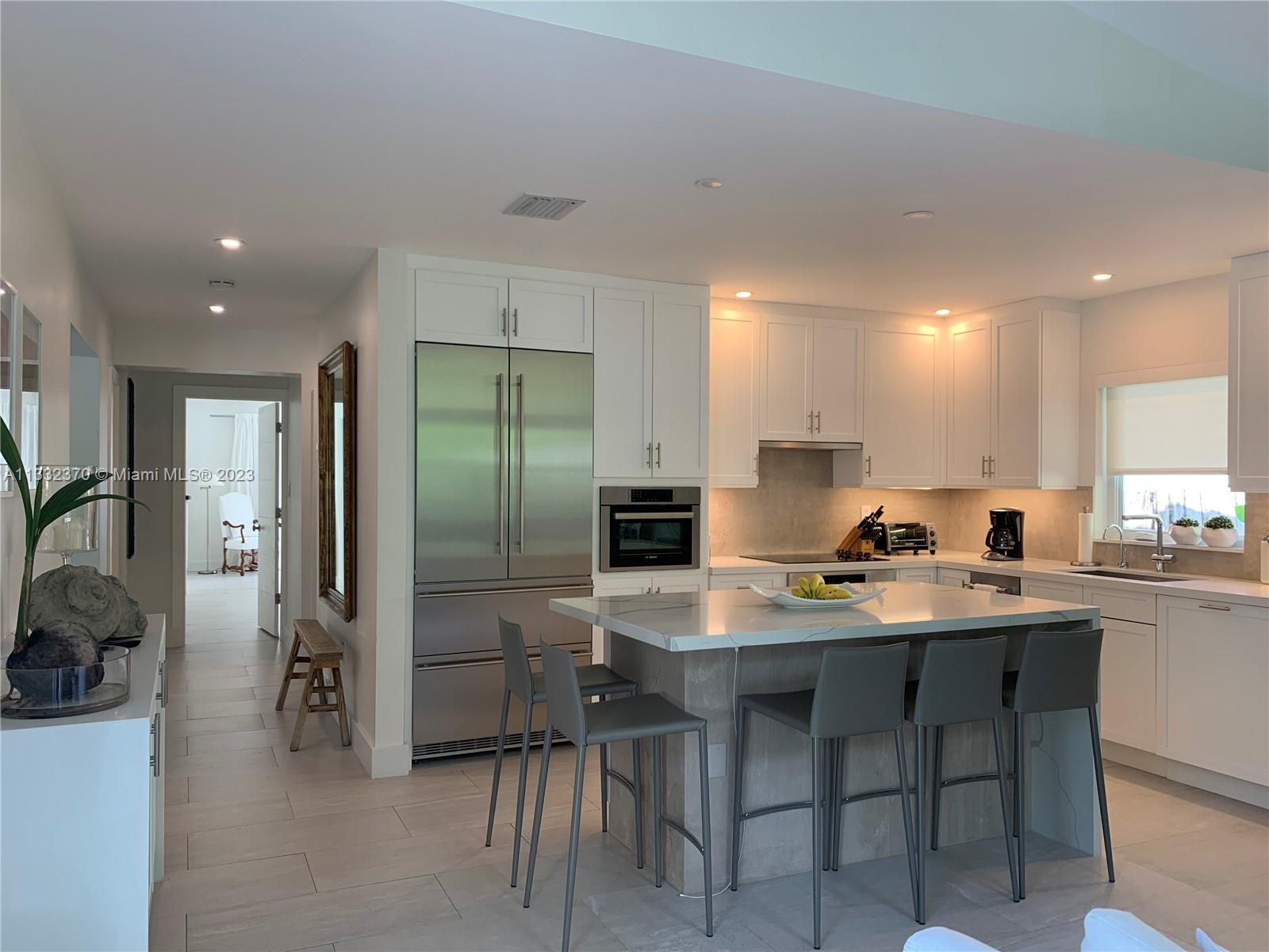 280 Hampton Lane Key Biscayne, FL 33149 - Photo 11 of 30 a kitchen with a sink and chairs