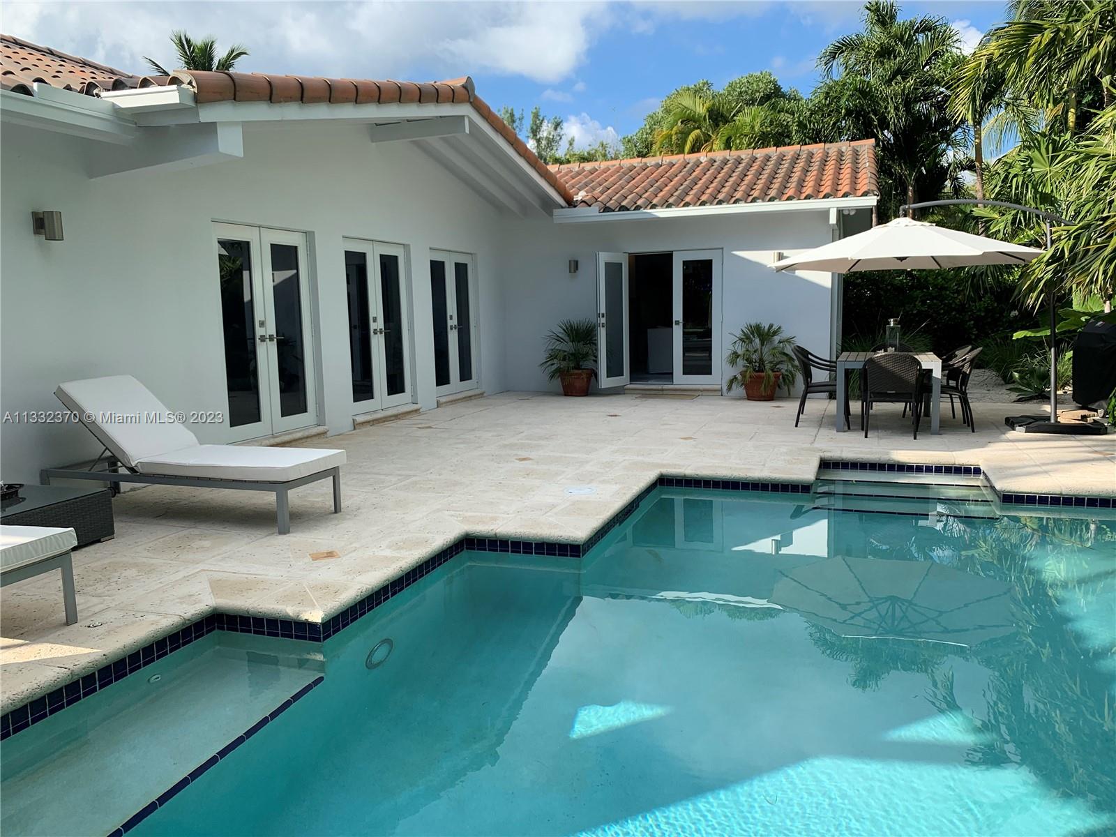 280 Hampton Lane Key Biscayne, FL 33149 - Photo 14 of 30 a view of a house with backyard porch and sitting area