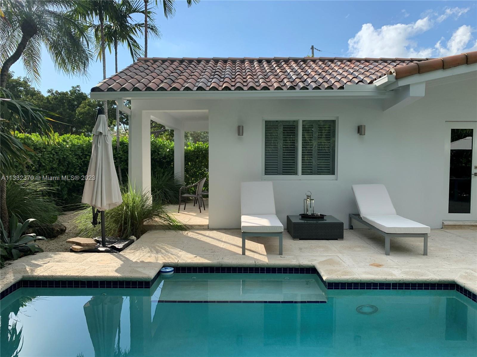 280 Hampton Lane Key Biscayne, FL 33149 - Photo 15 of 30 a view of a house with backyard and sitting area