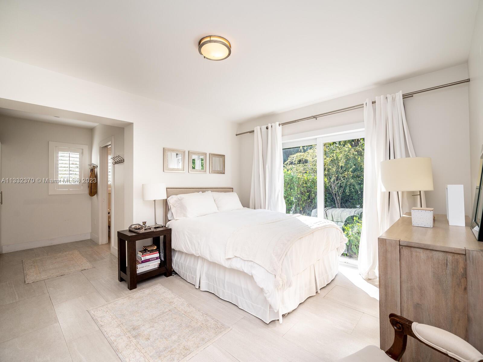 280 Hampton Lane Key Biscayne, FL 33149 - Photo 23 of 30 a bed room with a bed and a window