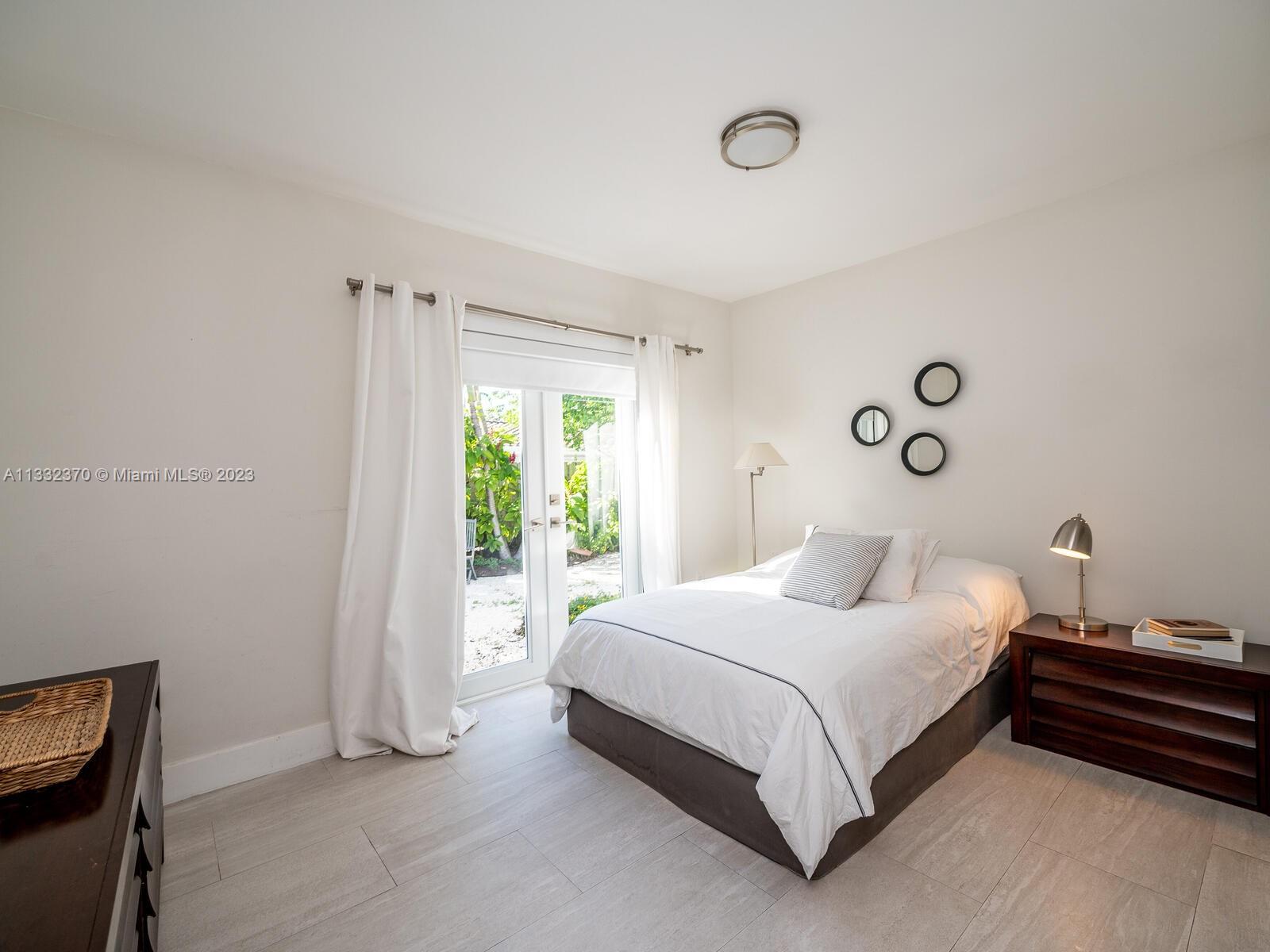 280 Hampton Lane Key Biscayne, FL 33149 - Photo 25 of 30 a bedroom with a bed and a window