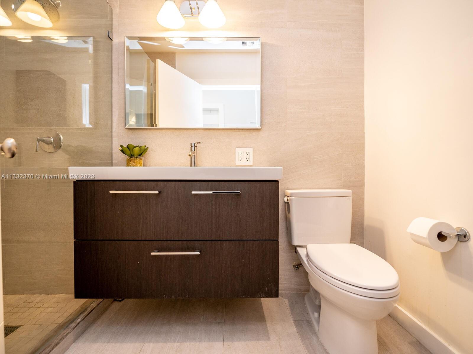 280 Hampton Lane Key Biscayne, FL 33149 - Photo 27 of 30 a bathroom with a toilet a sink and mirror