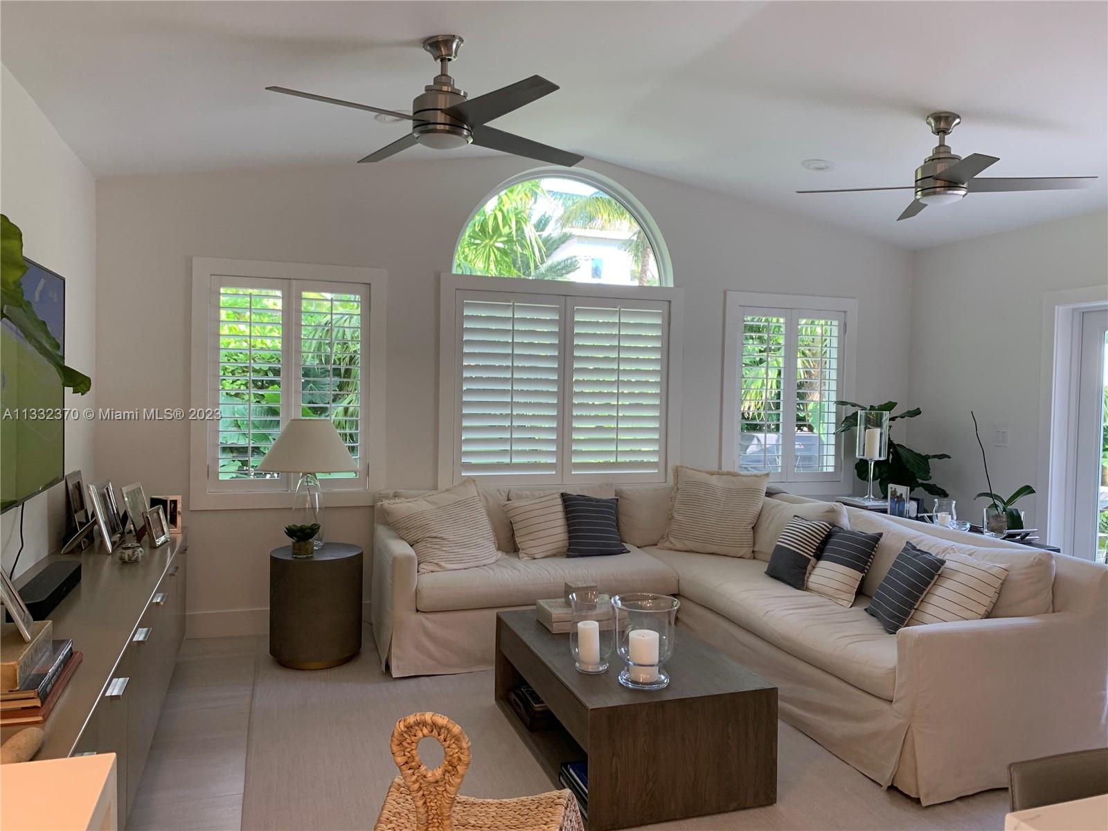 280 Hampton Lane Key Biscayne, FL 33149 - Photo 5 of 30 a living room with furniture a large window and a chandelier