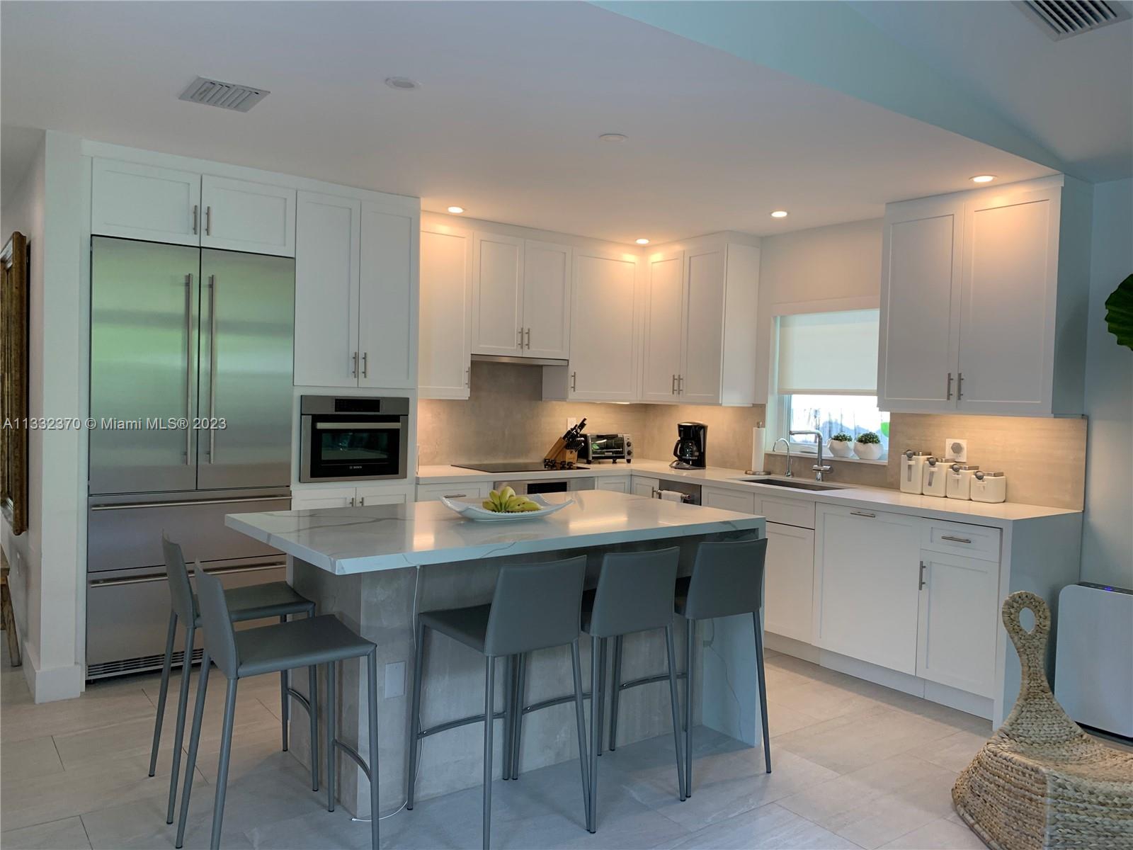 280 Hampton Lane Key Biscayne, FL 33149 - Photo 9 of 30 a kitchen with a table and chairs in it