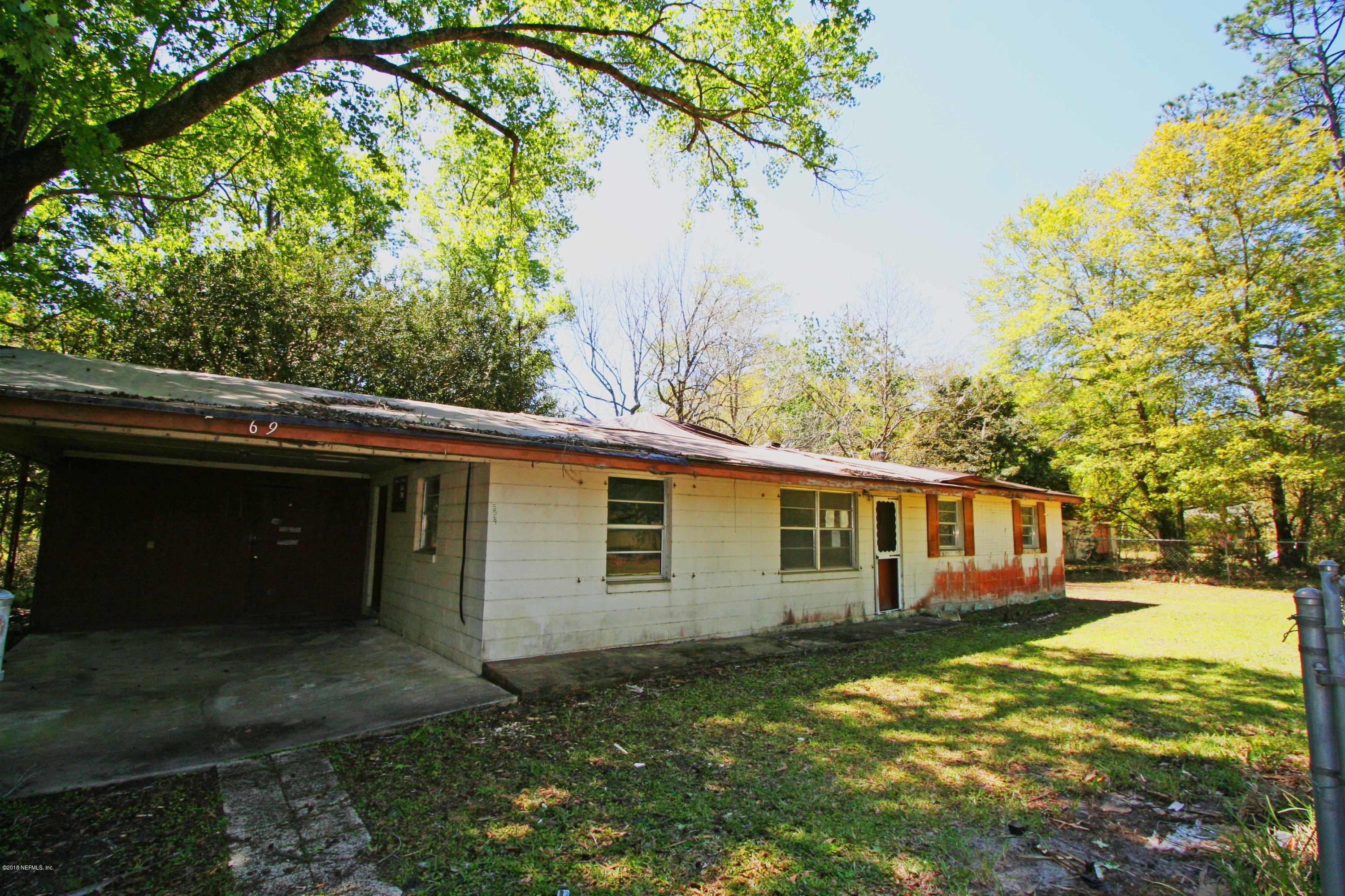 5569 Long Branch Road Jacksonville, FL 32234 - Photo 1 of 9 a view of backyard of house with green space