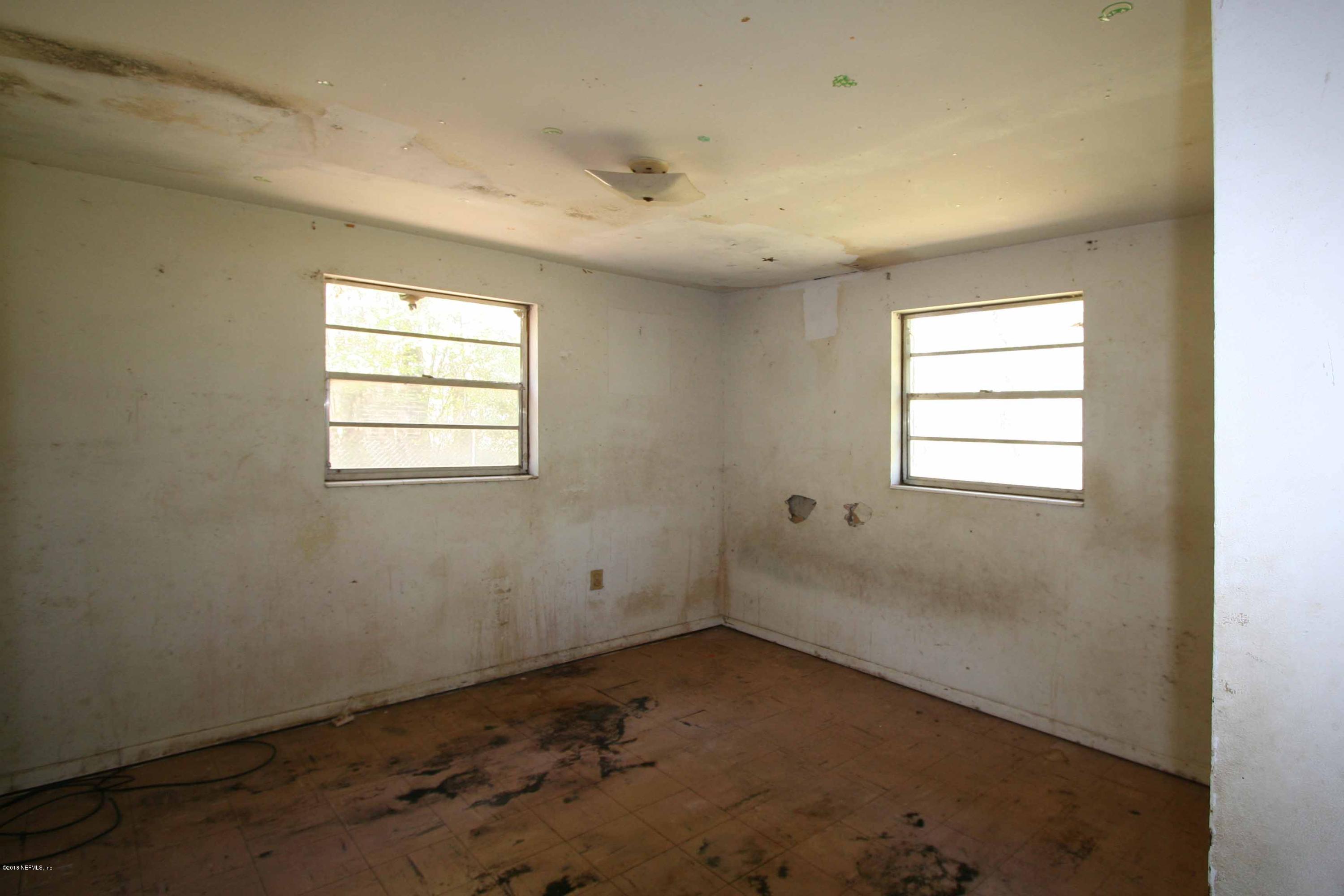 5569 Long Branch Road Jacksonville, FL 32234 - Photo 7 of 9 an empty room with windows