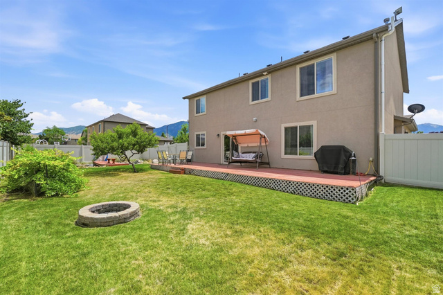 592 West 650 South Springville, UT 84663 - Photo 20 of 33 Expansive grassy yard with a stone-surrounded fire pit