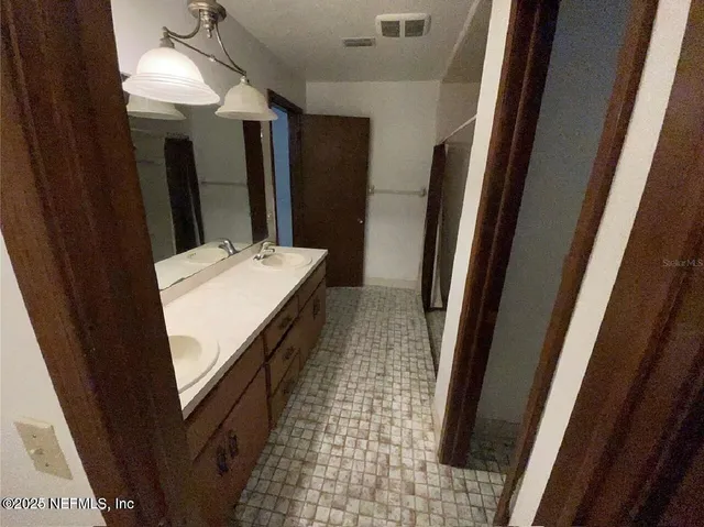 a bathroom with a sink a mirror and a shower