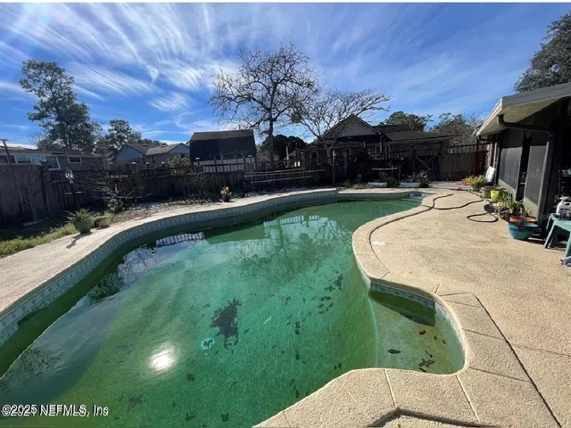 swimming pool view with a seating space