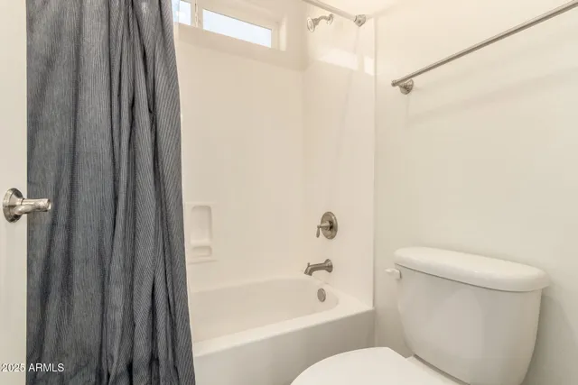 a bathroom with a toilet and a bathtub