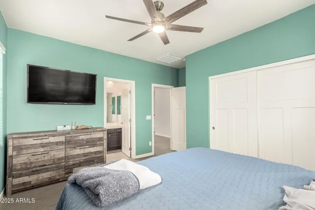 a bedroom with a bed and a flat screen tv