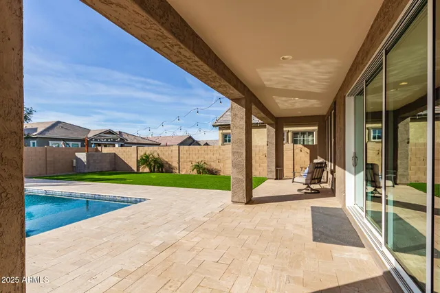 a view of a patio with a table and chairs