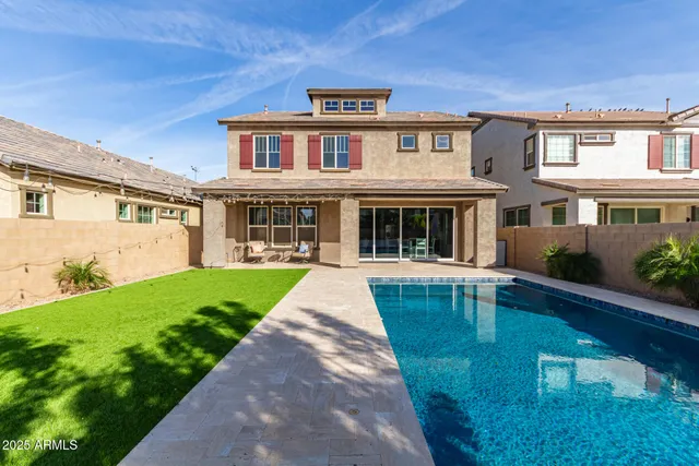 a front view of a house with yard and green space