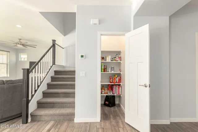 a view of a hallway with wooden floor and entryway