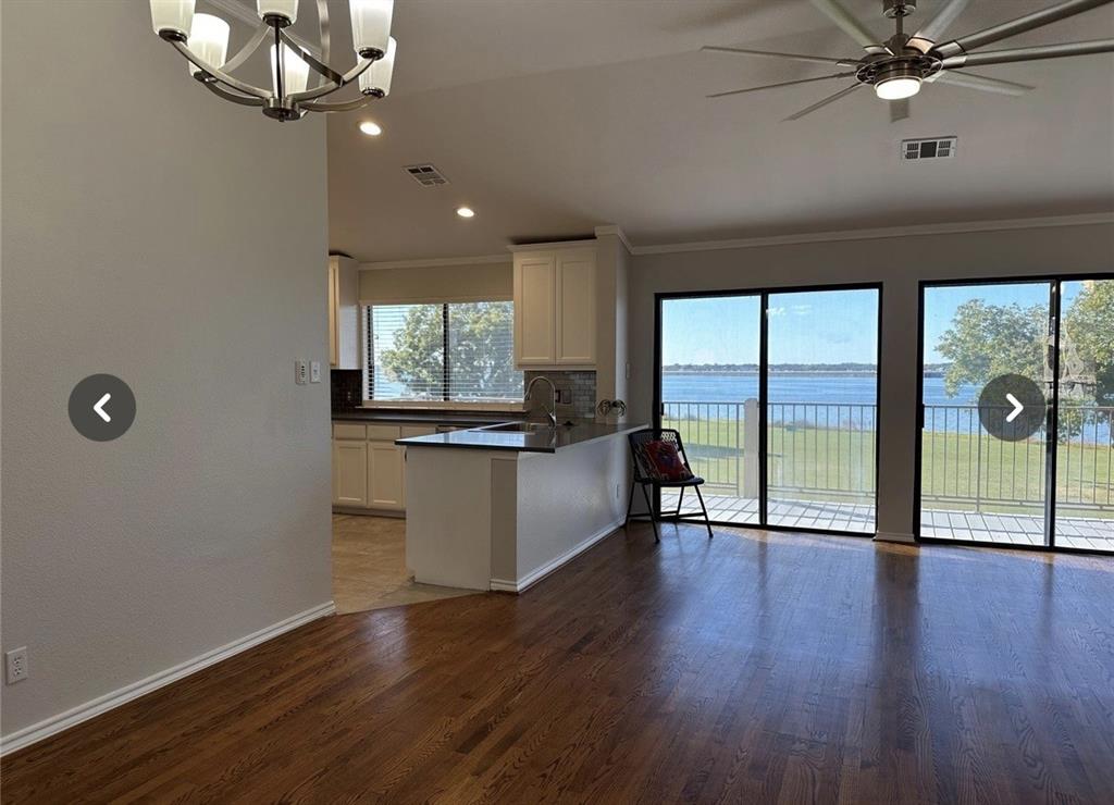 1882 Signal Ridge Place, Unit 1882 Rockwall, TX 75032 - Photo 11 of 19 an empty room with wooden floor fan and windows
