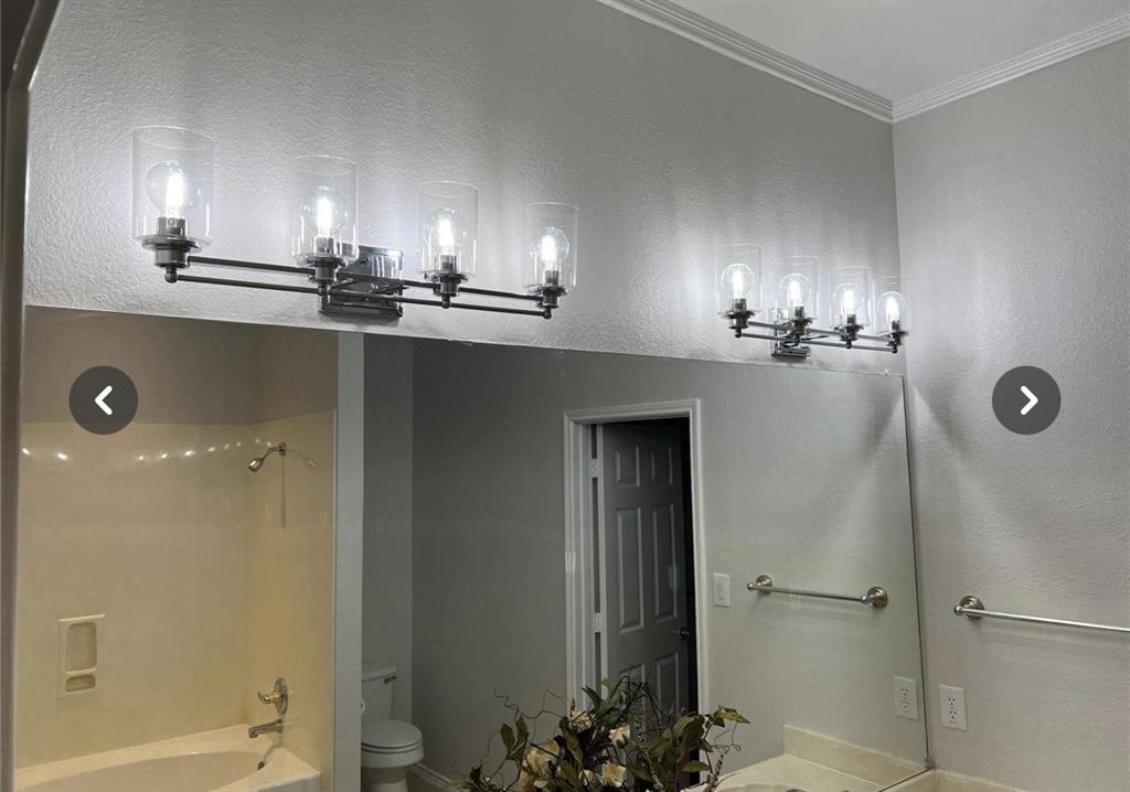 1882 Signal Ridge Place, Unit 1882 Rockwall, TX 75032 - Photo 13 of 19 a view of a bathroom with a shower a mirror and sink