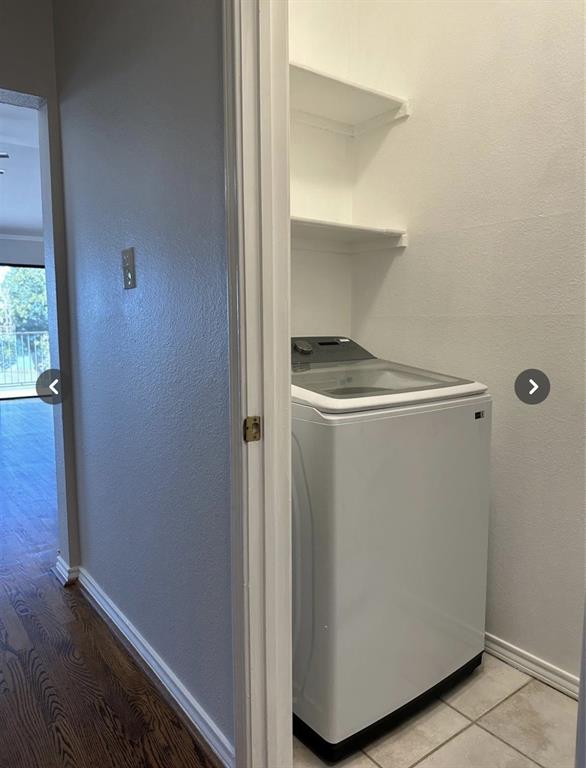 1882 Signal Ridge Place, Unit 1882 Rockwall, TX 75032 - Photo 16 of 19 a utility room with wooden floor washer and dryer