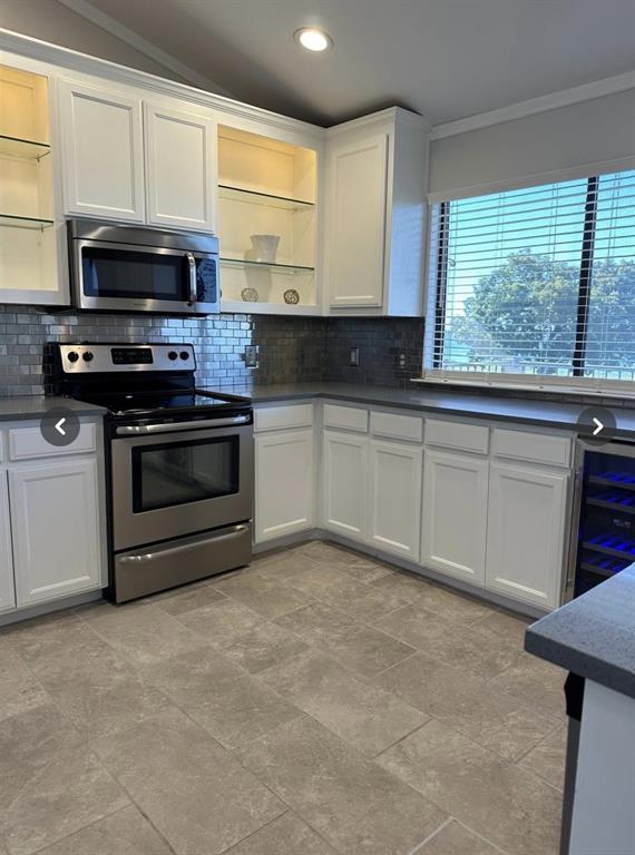 1882 Signal Ridge Place, Unit 1882 Rockwall, TX 75032 - Photo 9 of 19 a kitchen with stainless steel appliances a stove sink and microwave