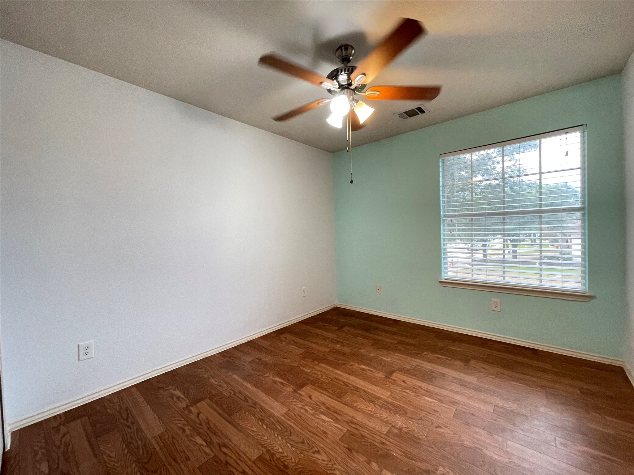 3638 Windhill Loop Round Rock, TX 78681 - Photo 19 of 32 Bright room featuring wood-finish flooring, a ceiling fan with integrated lighting, and a large window with horizontal blinds