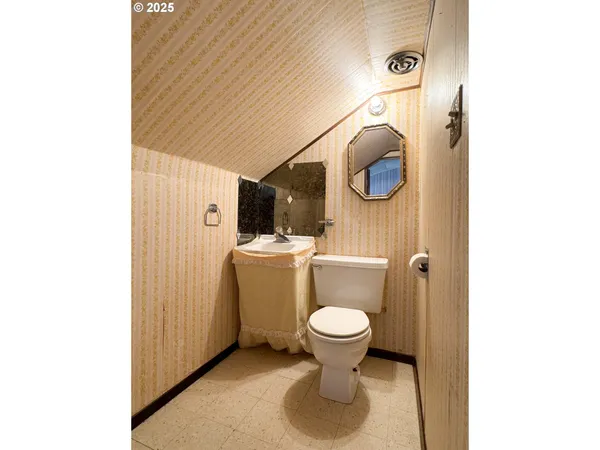 a bathroom with a sink toilet and mirror