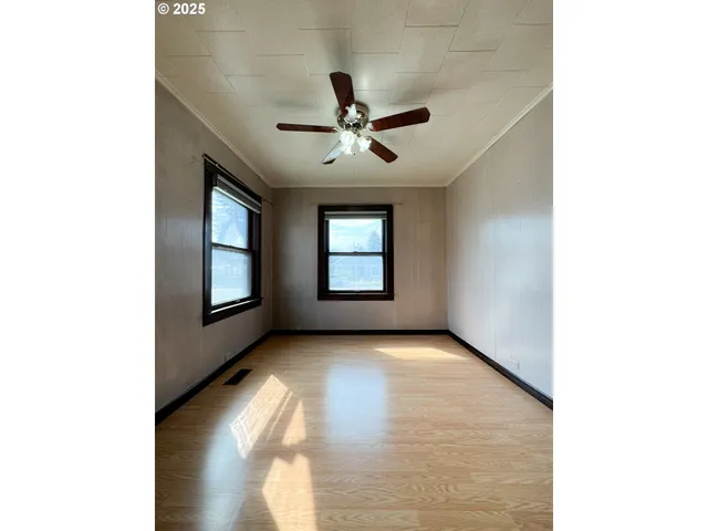 a view of a livingroom with a ceiling fan and window