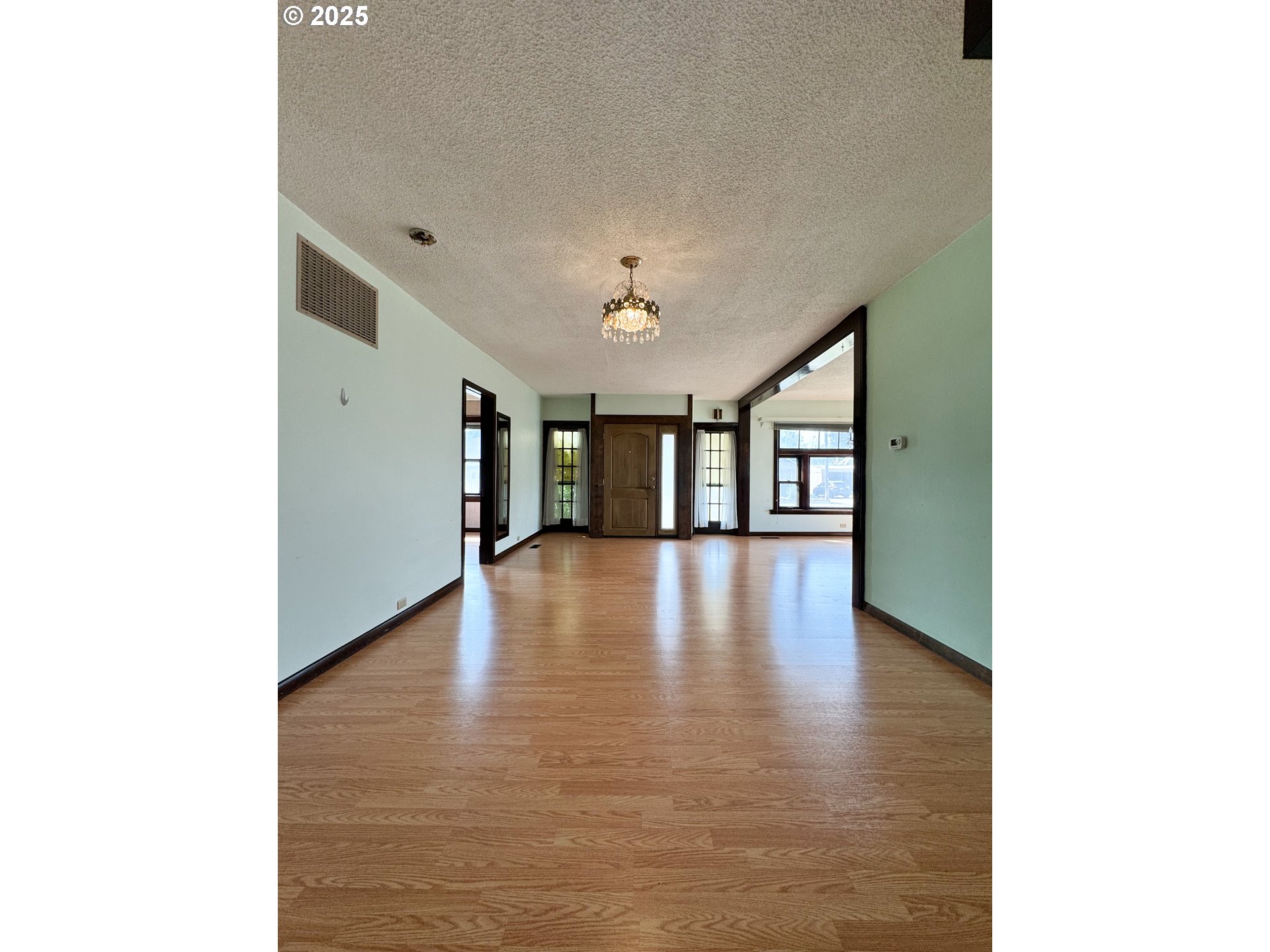 1050 Elm Street Baker City, OR 97814 - Photo 3 of 28 a view of an empty room with window and wooden floor