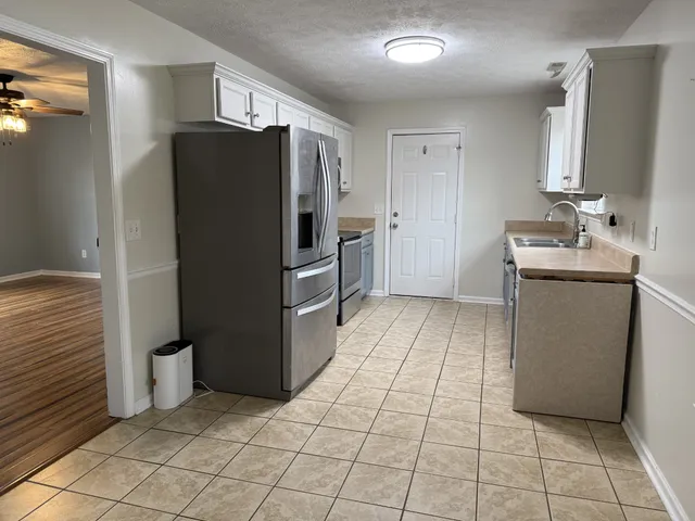 a kitchen with stainless steel appliances a refrigerator and a sink