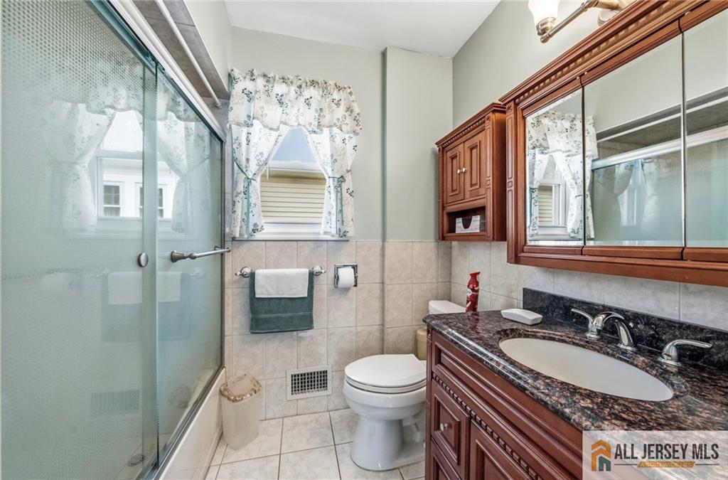 50 3rd Street Fords, NJ 08863 - Photo 11 of 36 a bathroom with a sink a toilet and shower