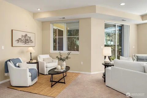 a living room with furniture and a floor to ceiling window