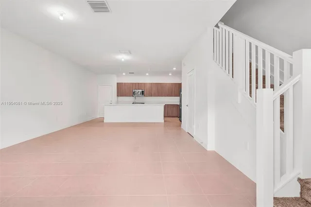 a view of a hallway with a kitchen