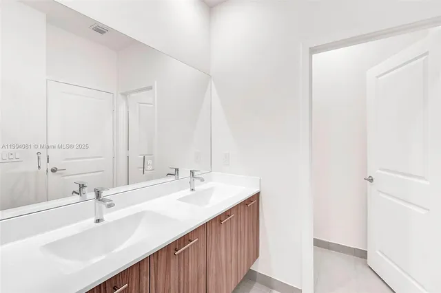 a bathroom with a sink a mirror and a bathtub