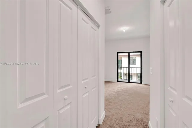 a view of a hallway with an entryway