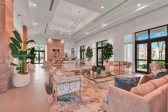 a living room with furniture potted plant and a large window