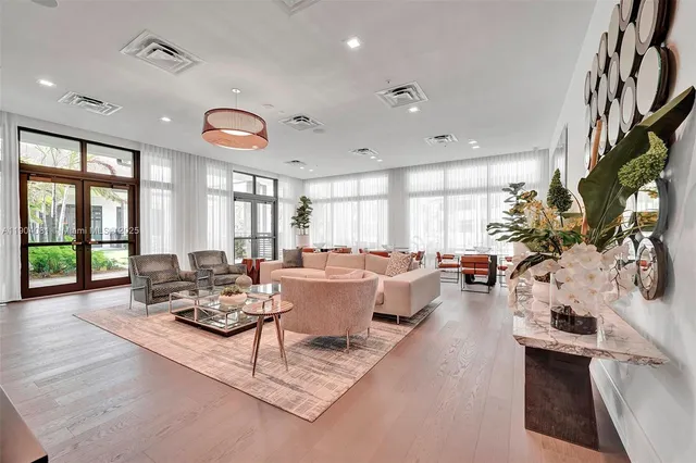 a living room with furniture fireplace and a large window