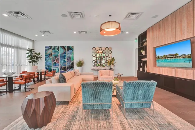 a living room with furniture a rug and a large window