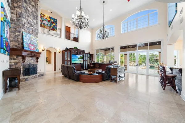 a living room with fireplace furniture and a chandelier