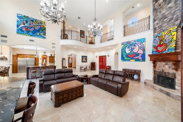 a living room with furniture and a chandelier