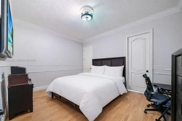 a bedroom with a bed and a night stand