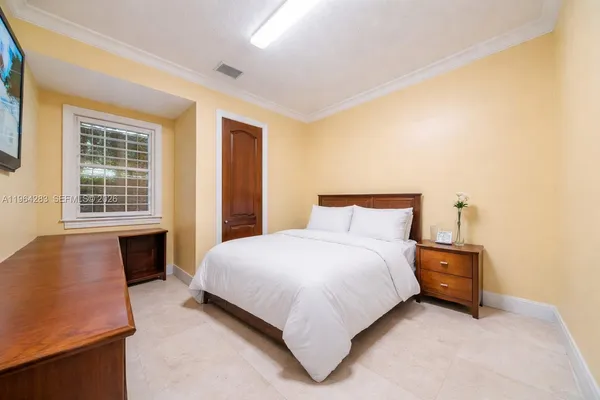 a bedroom with a bed couch and a window