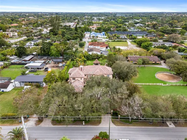 an aerial view of a residential houses with outdoor space
