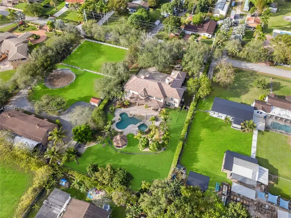 an aerial view of residential houses with outdoor space
