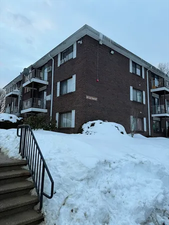 a front view of a house with yard and stairs