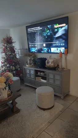 a living room with furniture and a floor to ceiling window