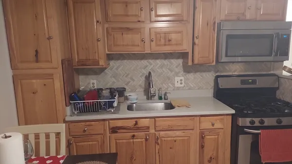 a kitchen with granite countertop a sink and cabinets