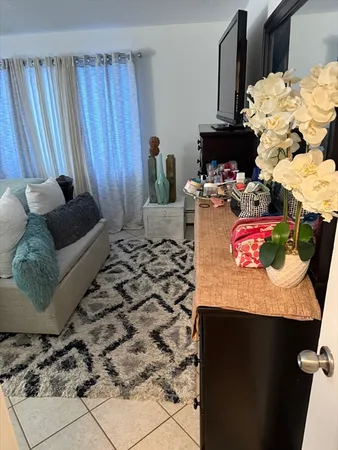 a bedroom with a bed and a couch