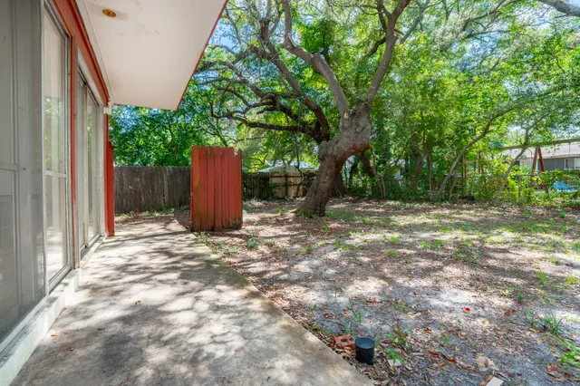 a backyard of a house with a tree