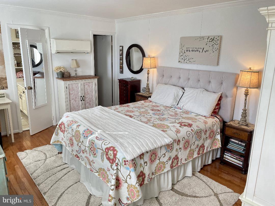 17648 Canby Road Leesburg, VA 20175 - Photo 7 of 12 a bedroom with a bed and dresser with mirror