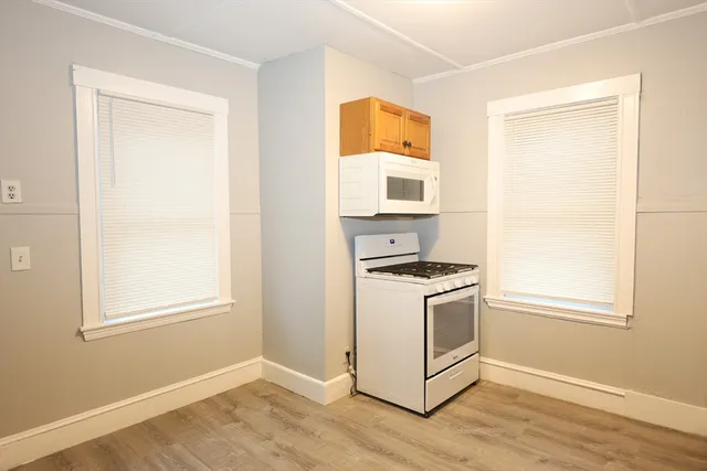 a kitchen with a stove a sink and a window
