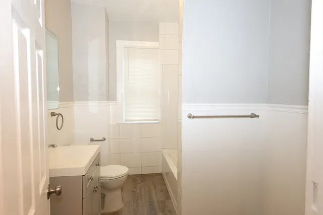 a bathroom with a granite countertop toilet and a shower