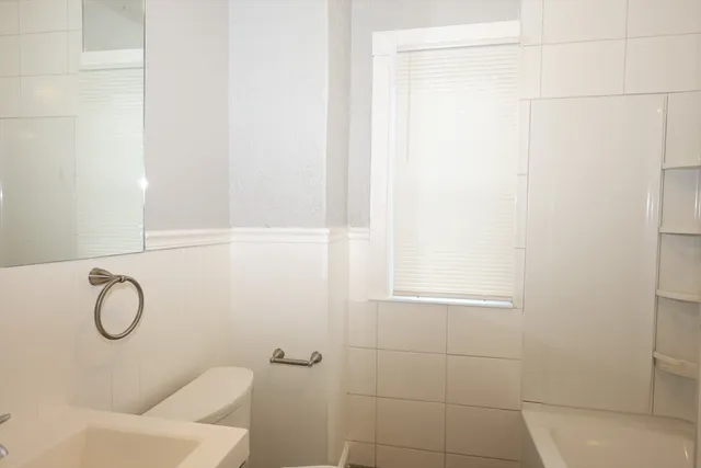 a bathroom with a shower curtain and a window